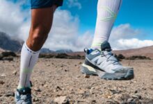 Running shoes and athletic gear for trail running on rocky terrain in outdoor mountains environment.