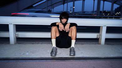 Running insights, athlete resting after run, urban background, fitness and training recovery concept, modern athletic lifestyle.