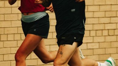 Running insights, athletes training outdoors, running on a wet surface, focusing on performance and endurance, wearing sportswear, brick wall background, passionate runners enhancing their fitness.
