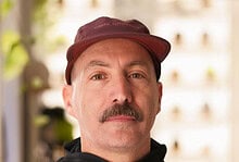 1. Portrait of a middle-aged man in running gear, showcasing dedication to running and fitness, indoors with natural lighting and blurred background.