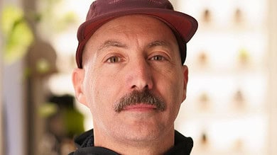 1. Portrait of a middle-aged man in running gear, showcasing dedication to running and fitness, indoors with natural lighting and blurred background.