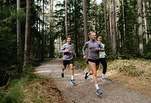 1. Group of diverse runners jogging through a forest trail, promoting outdoor running, fitness, and running insights for athletes.