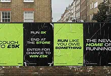 Motivational running wall with Couch to 5K, end at the store, and run like you owe something messages, encouraging marathon prep and taper week success.