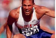 Athlete in mid-race sprint, showcasing explosive power and speed during a track event.