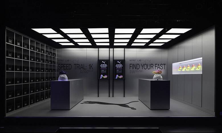 Modern PUMA Nitro Lab store display showcasing innovative running shoes in a sleek, high-tech environment during London marathon weekend.