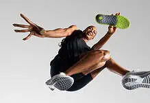 Athlete mid-air in a dynamic running pose, showcasing athleticism and energy, wearing modern running shoes.