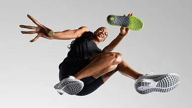 Athlete mid-air in a dynamic running pose, showcasing athleticism and energy, wearing modern running shoes.