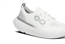 White Men's OOmy Stride X1 running shoe with breathable upper and cushioned sole, ideal for running and athletic activities.