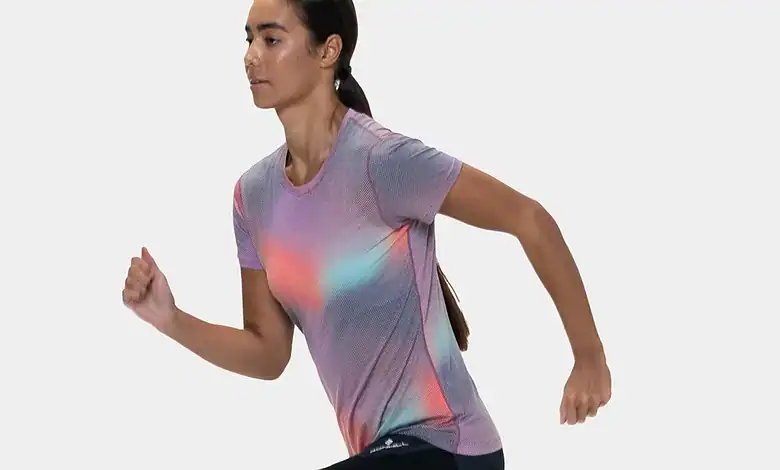 Female runner in athletic gear captured mid-stride, showcasing dynamic movement and focus, ideal for running and fitness content.