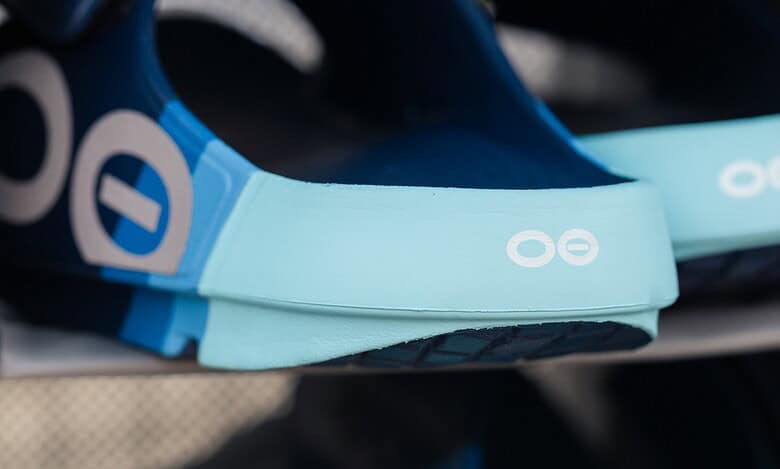 Close-up of blue and black running shoes and gear on display at Running Insights store, highlighting athletic footwear and accessories for runners.