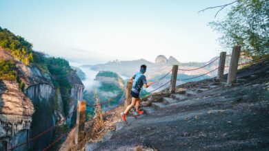 A trail runner crossing a mountain path above Wuyishan’s sandstone peaks